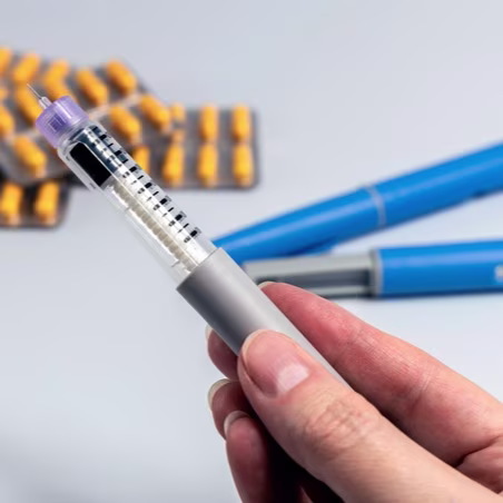 Hand Holding Ozempic Injection Pen