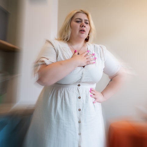 Overweight young woman feel chest pain at home