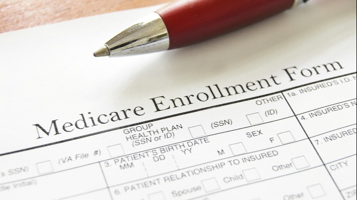 Medicare Enrollment Form and a red pen