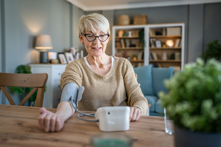 Senior caucasian woman check blood pressure measure device