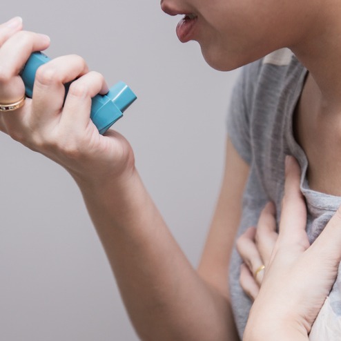 Woman Using Inhaler for COPD Relief