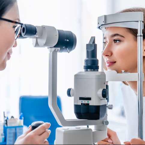 Woman getting an eye exam by an optometrist. 