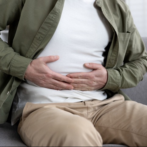 Man with Stomach Pain on Couch