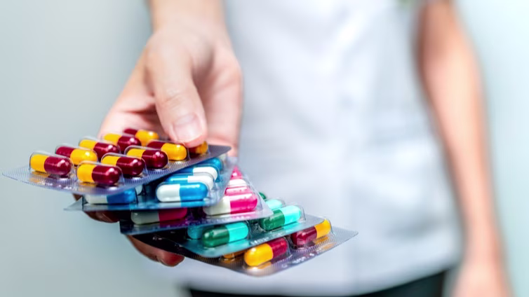 Pharmacist or doctor hand holding pack of antibiotic