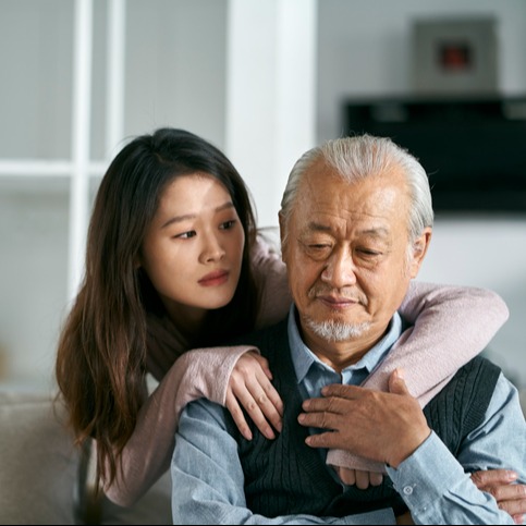 Young asian adult daughter conforting senior father at home