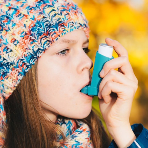 Asthma patient girl inhaling medication