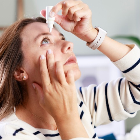 Using Xiidra: Young Woman Applying Eye Drops for Dry Eye Relief