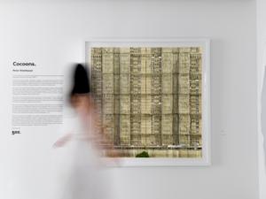 Woman walking in front of Cocoons artwork