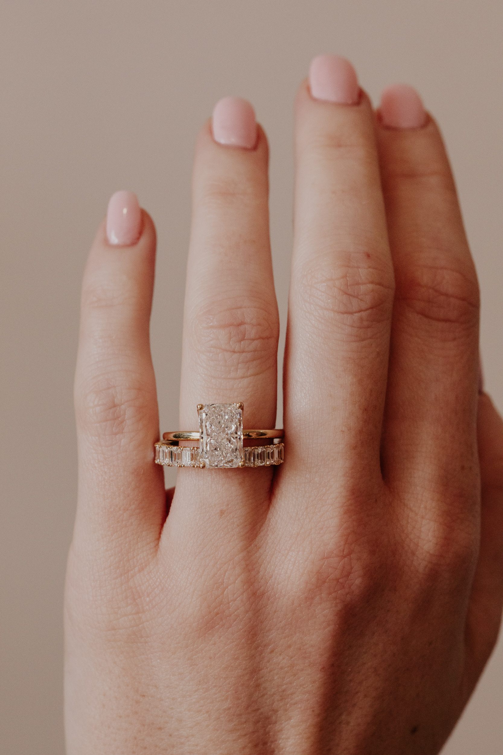 A radiant cut diamond engagement ring paired with a diamond band.