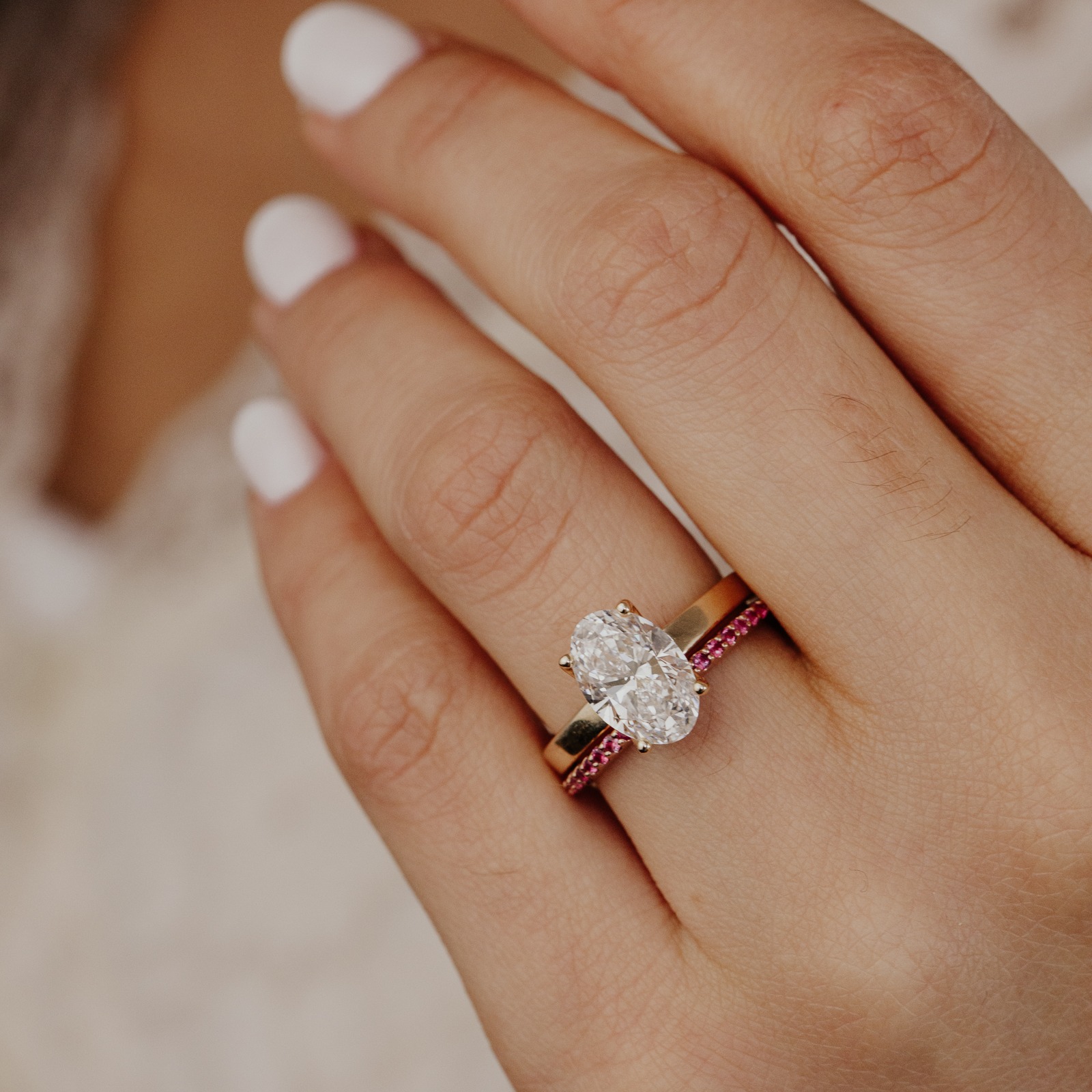 The Jenna Ruby Band stacked with The Octavia Oval Ring on a models hand.