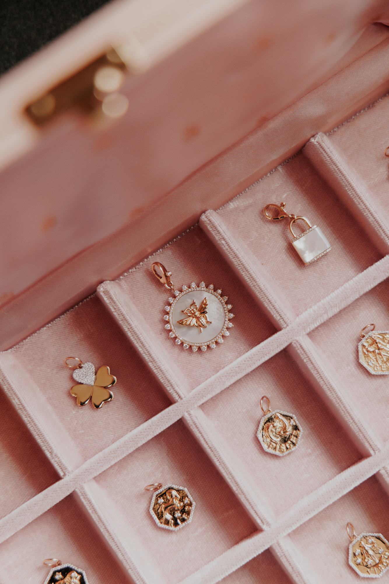 Story We Wear charms in a pink velvet jewelry box.