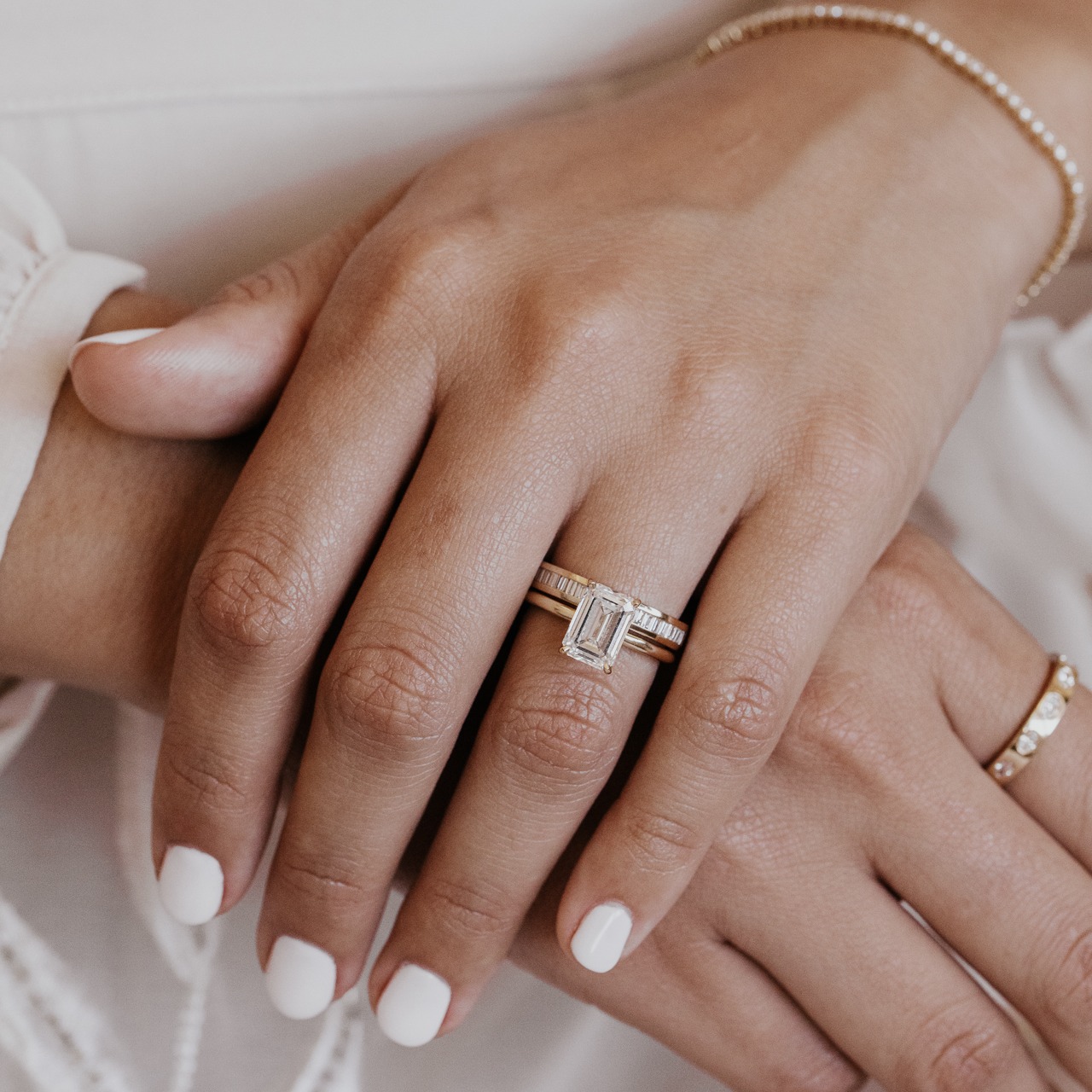 The Maeve emerald cut diamond ring paired with the Suki Diamond Band