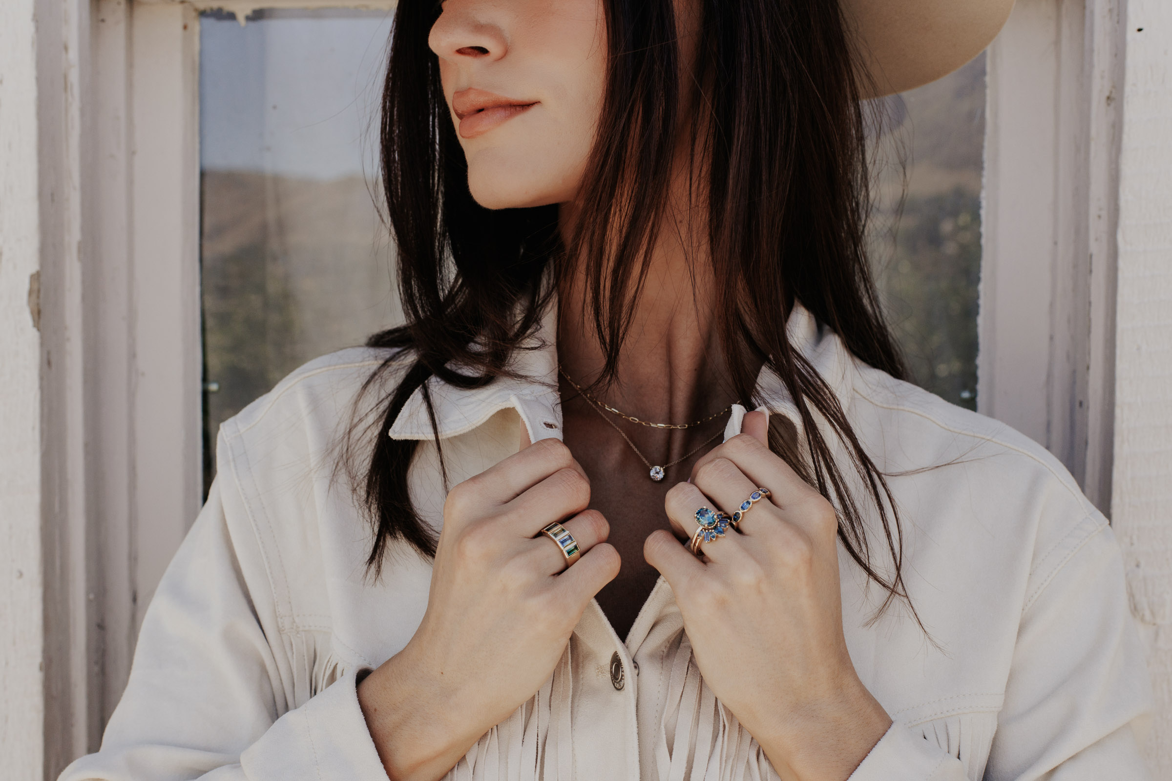 Model wearing multiple Montana sapphire rings from the Voyage collection.