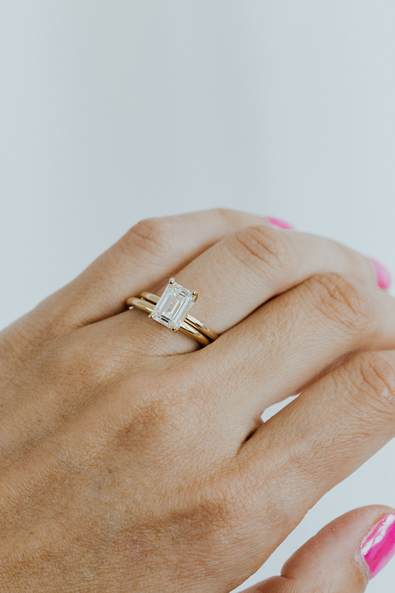 A close up of the Maeve diamond engagement ring with a gold Maeve wedding band.