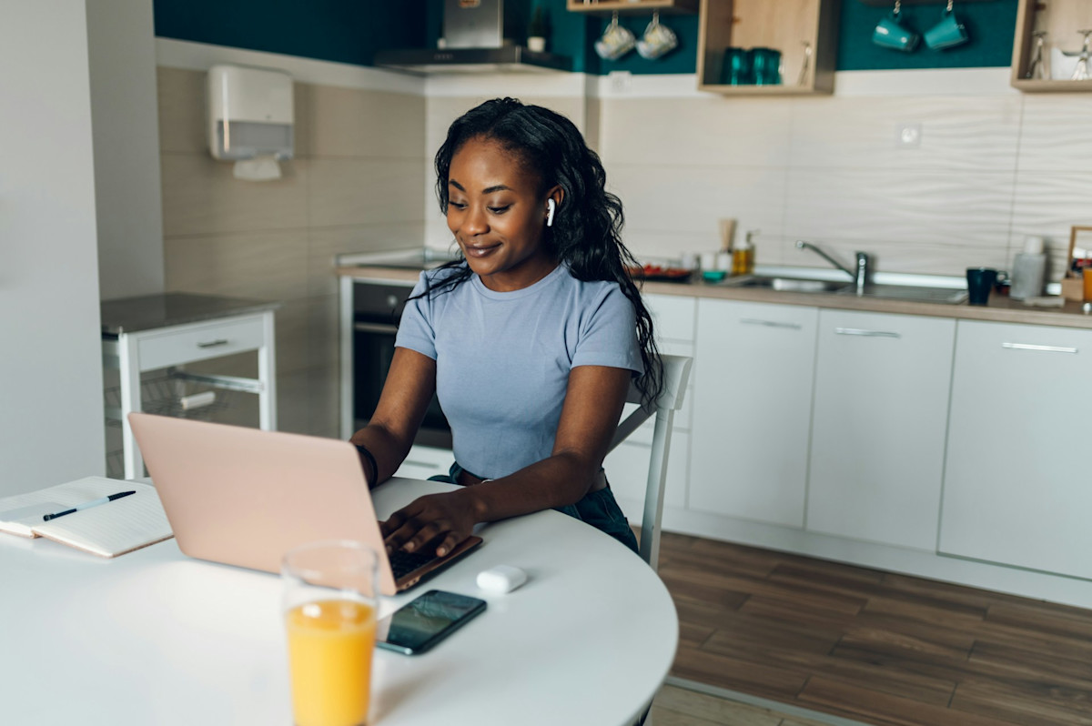 female remote worker in kitchen