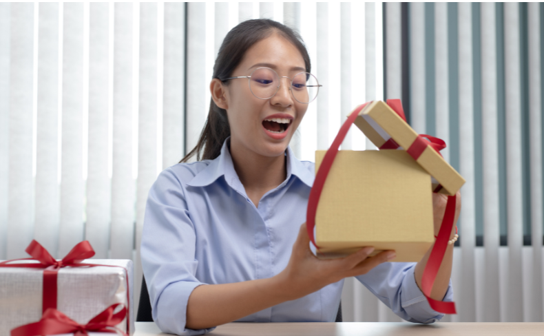 Person smiling opening present