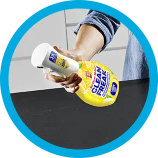A person cleaning a kitchen countertop with CleanFreak - Lemon Scented