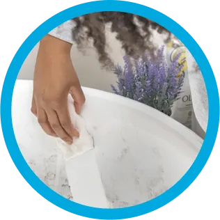 Mr. Clean wipe cleaning a dirty bathtub