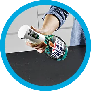 A person cleaning a kitchen countertop with CleanFreak Unstopables