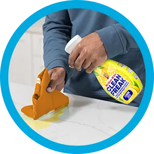 A person cleaning a kitchen countertop with CleanFreak - Lemon Scented