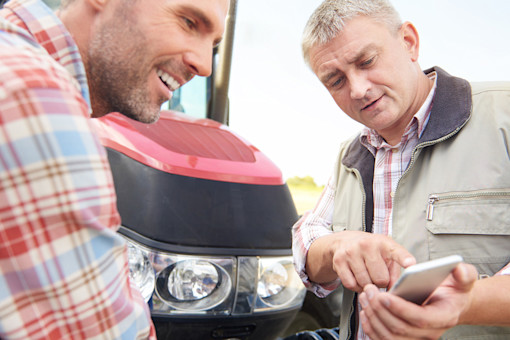 Farmers looking at phone