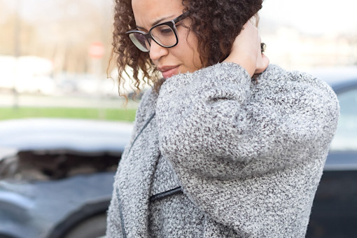Woman holding neck after a car crash