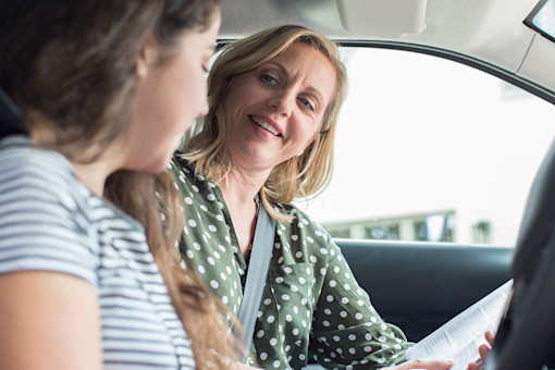 Female driving instructor talking to pupil