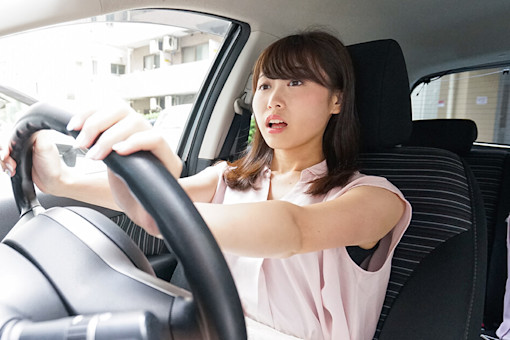 Woman driver with shocked expression