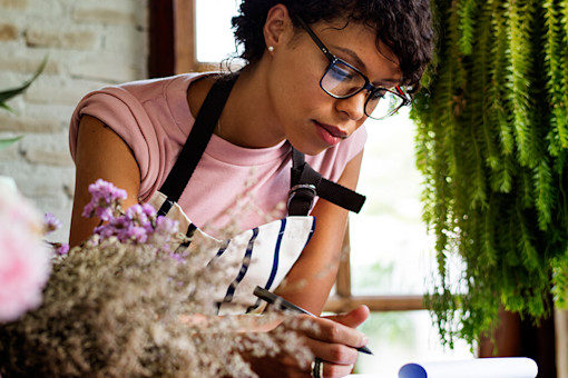 Flower shop owner taking notes