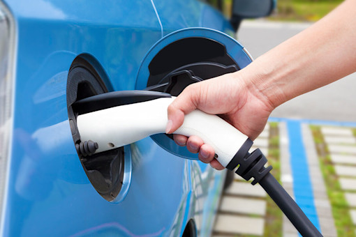 Hand holding electric car charger