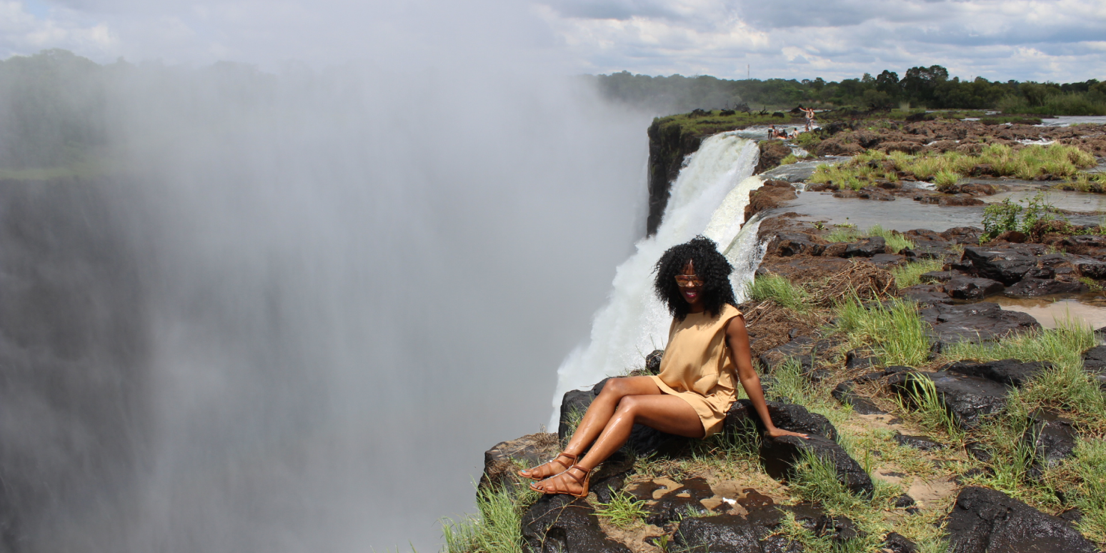 A hero image of Judith Meyer sitting at the edge of a waterfall