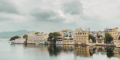 Udaipur's Taj Lake Palace: Luxurious white marble palace seemingly floating on the serene waters of Lake Pichola.