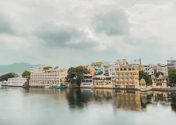 Udaipur's Taj Lake Palace: Luxurious white marble palace seemingly floating on the serene waters of Lake Pichola.