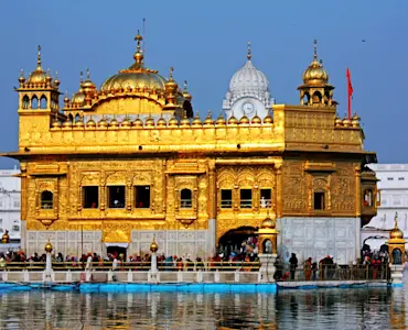 Embrace Amritsar's spiritual essence with TravelTaxi - The serene Sarovar at the Golden Temple.