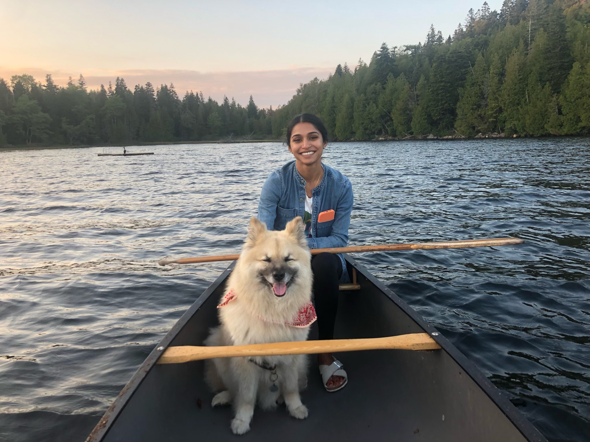 Photo of Mili and her dog on a canoe on a lake