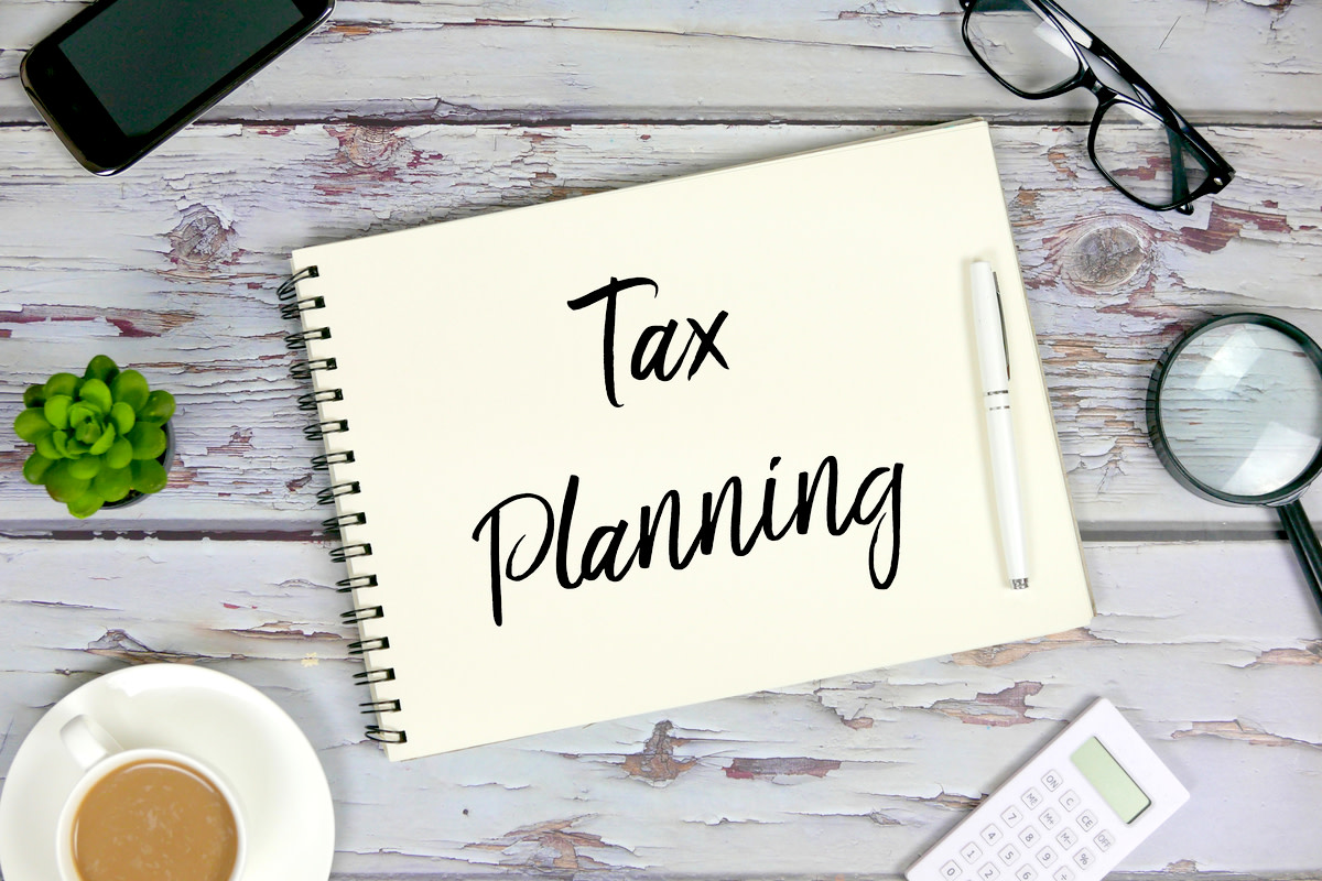 pen and notebook written with Tax Planning