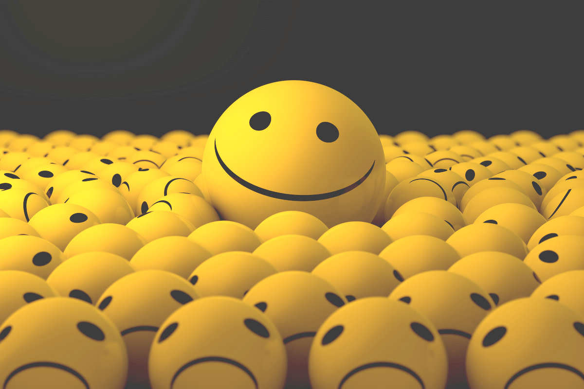 3D rendering of a large smiling ball among a lot of sad