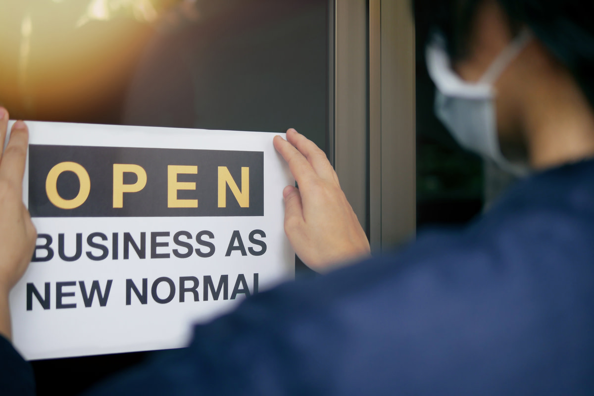 Rear view of business owner wearing medical mask