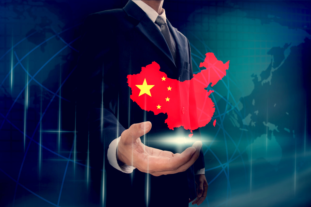 Businessman showing map of China on globe background