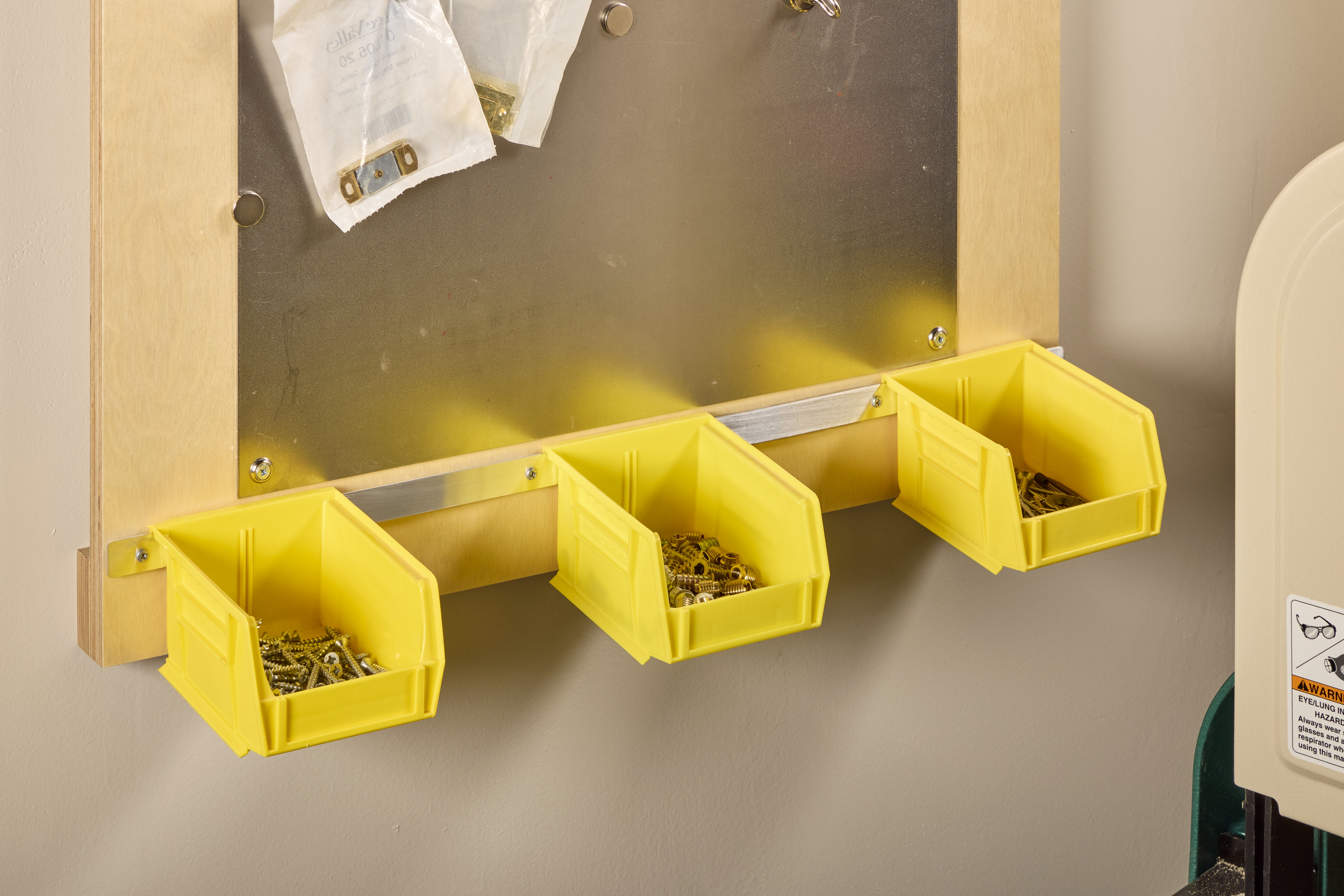 yellow bins held up with scews and washers to hold hardware