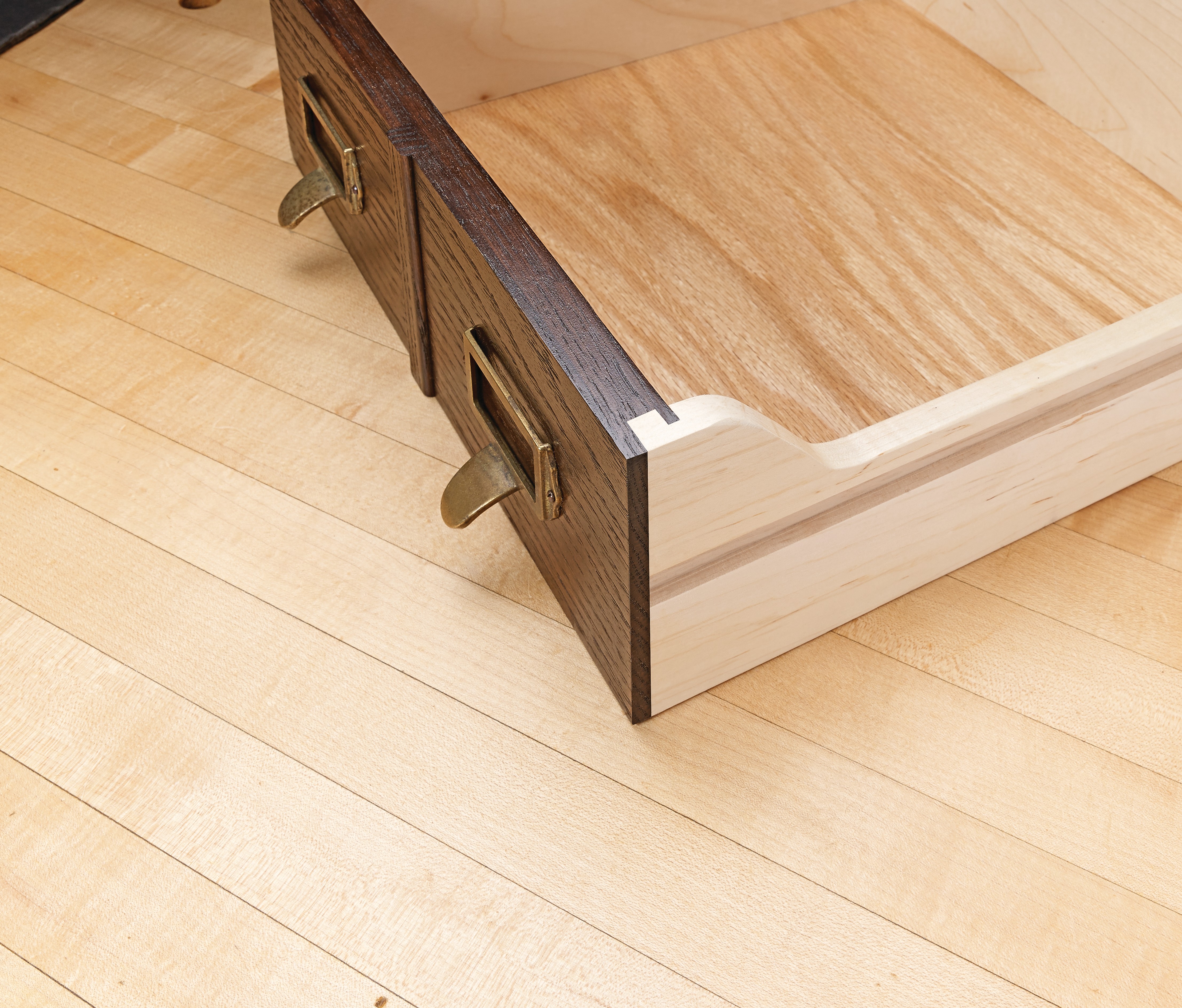 inerlocking rabbet jointed drawer with dark stained front and light sides