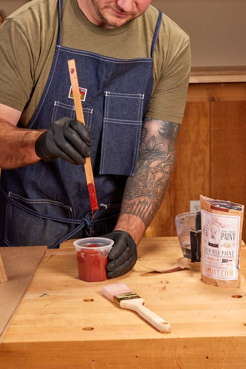 mixing water and powdered red milk paint until creamy consistency