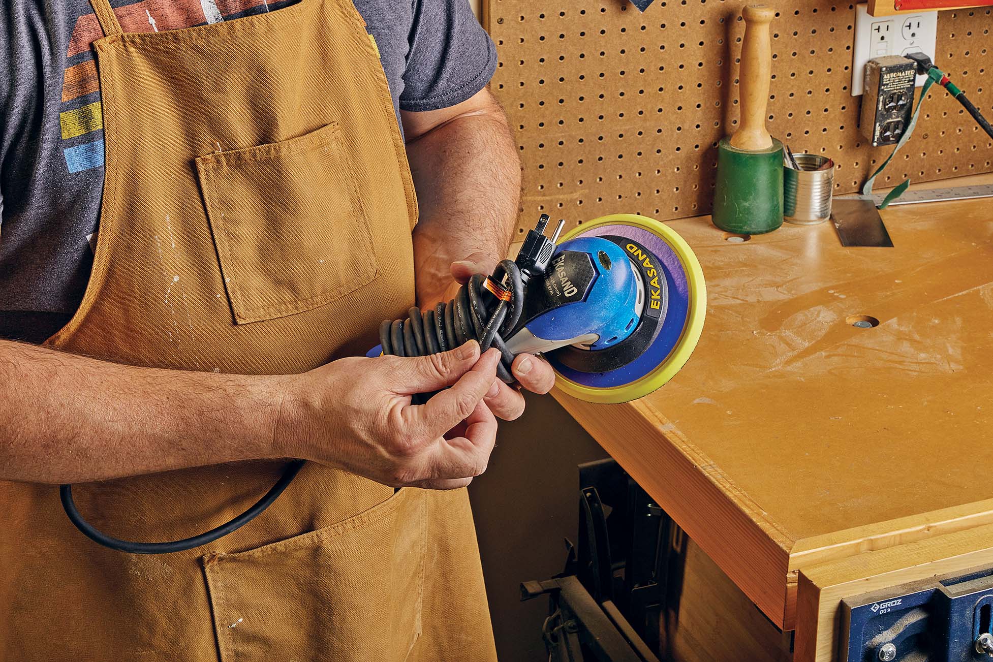 pluf of orbital sander being pushed through the other side of the loop