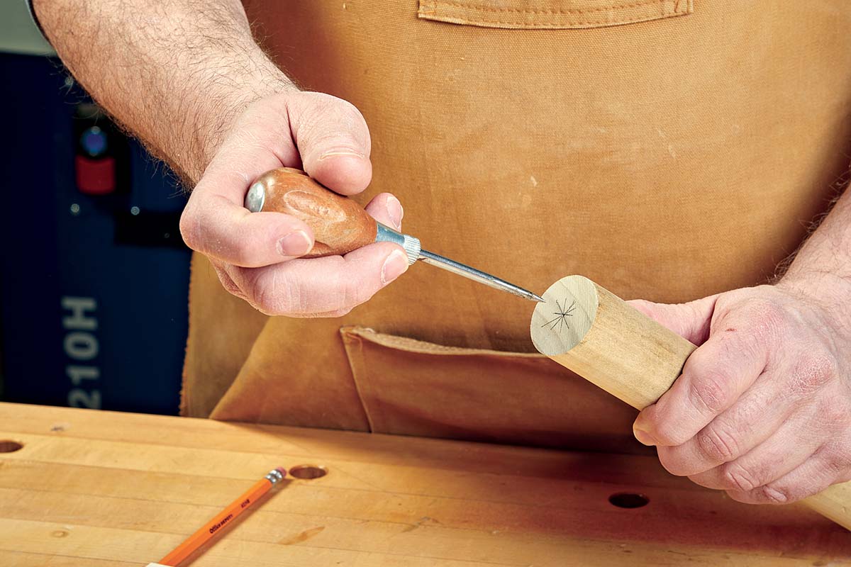 using awl to divot starter hole on dowel