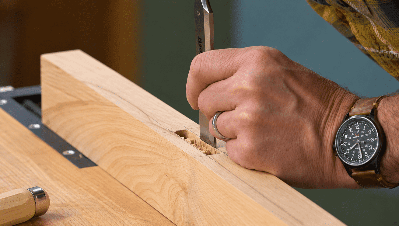 cleaning up side of mortise with chisel