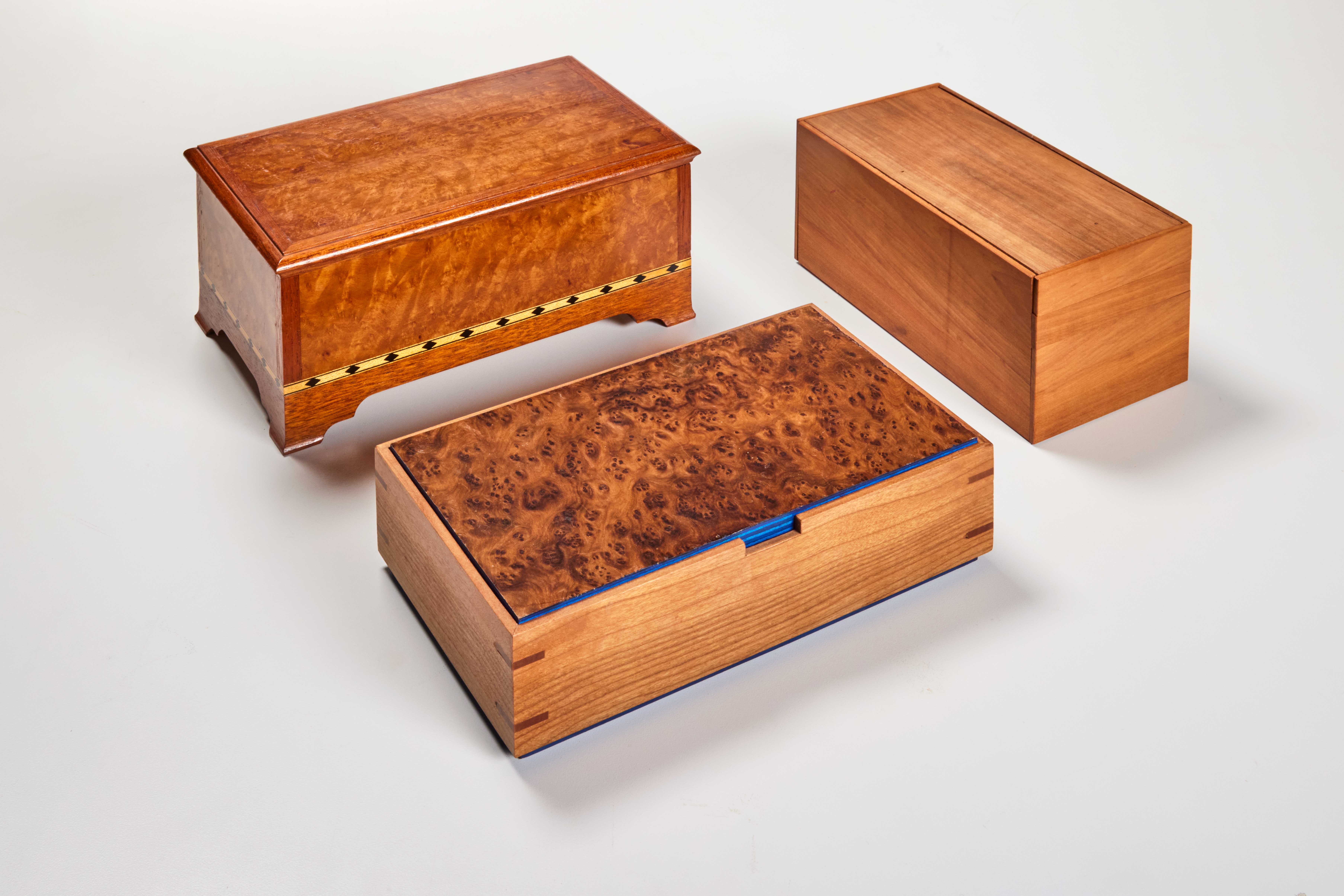 three wood boxes with various shapes and designs