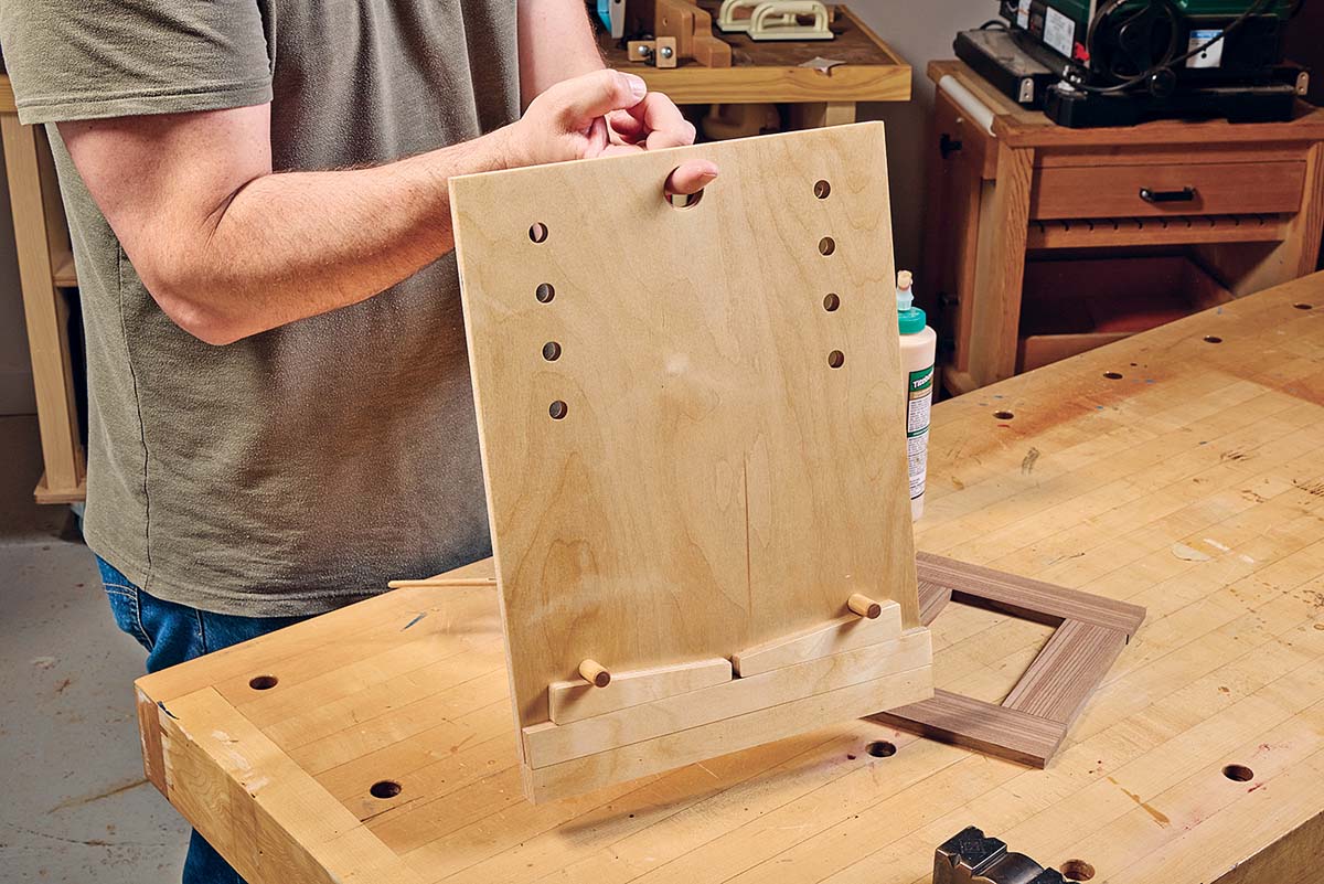 wood board with dowel slots to hold workpiece while drying