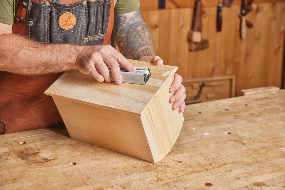 using sanding block to go over wood filler and smooth overal surface