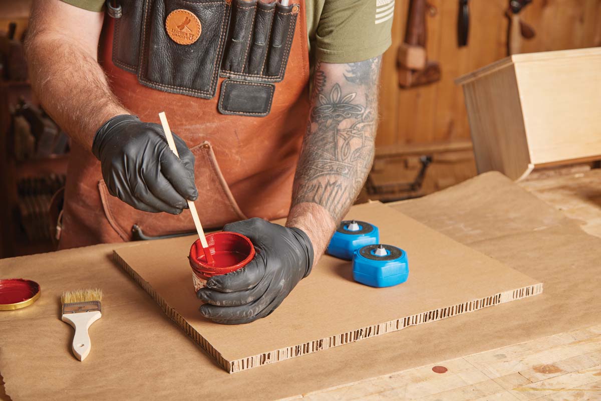 red linseed paint being mixed