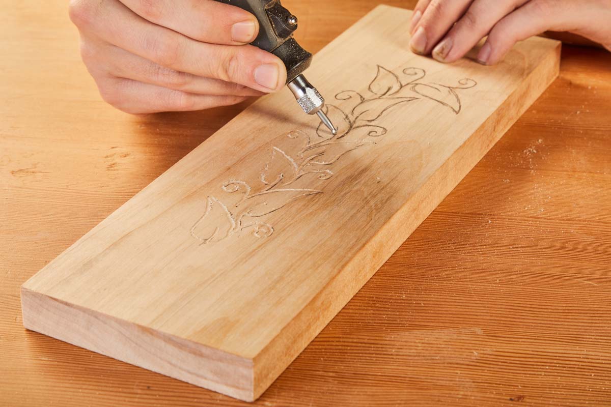 ball shaped Dremel bit cutting vines into wood